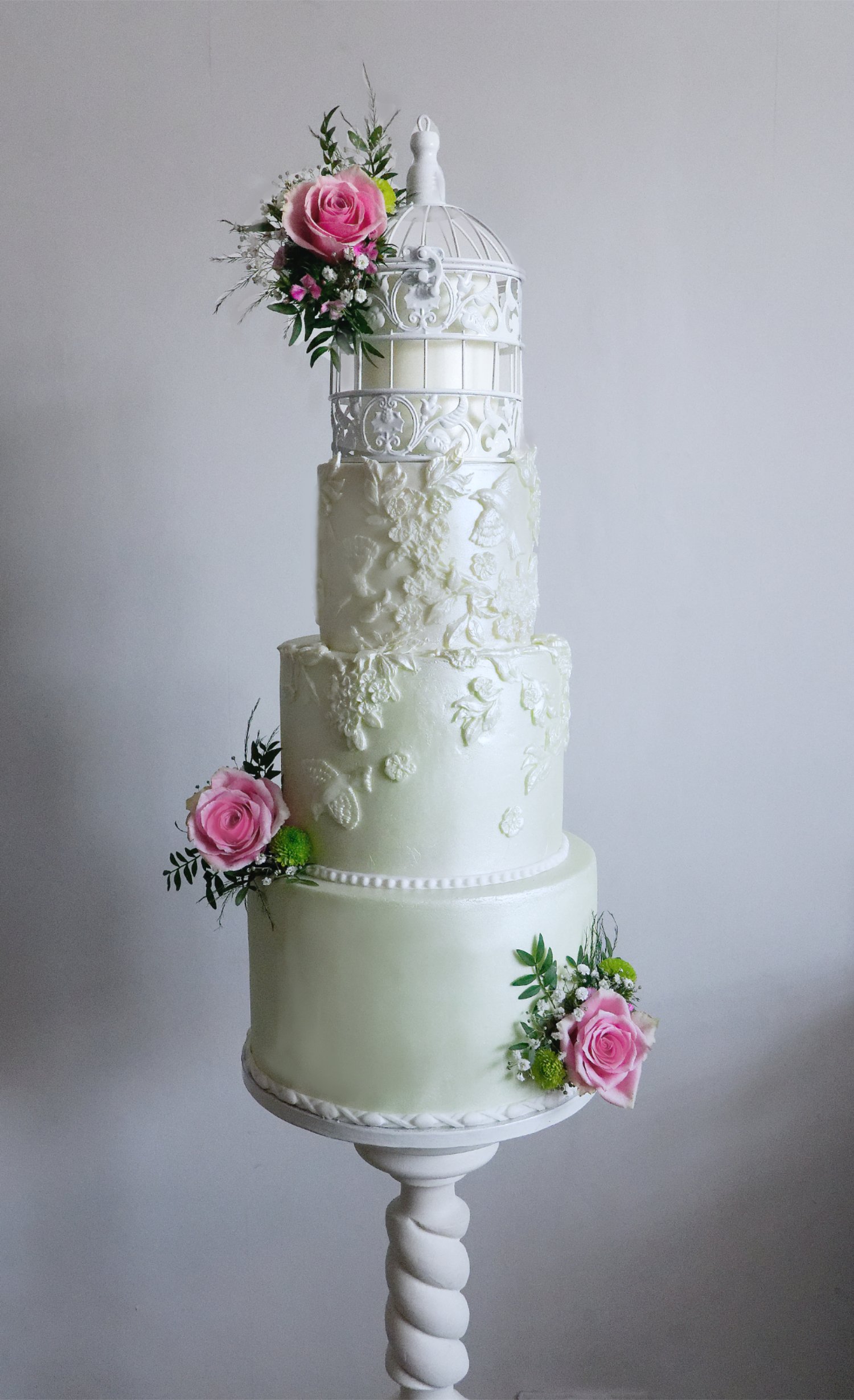 Birdcage wedding cake with bas relief detailing and retro feel. Fresh floral decoration.